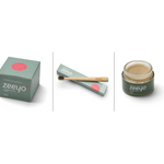 A three-panel composite image of Zeeyo dog dental products. The left panel shows the sage green 'Canine Dental Paste' box; the center panel features the bamboo toothbrush resting on its packaging; the right panel shows an open glass jar of the creamy, natural dental paste. All panels highlight the minimalist, premium branding.